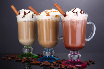 Layered coffee in glass on table on grey background