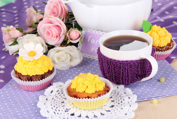 Delicious beautiful  cupcakes on dining table close-up