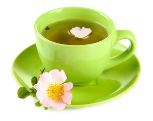 Cup of herbal tea with hip rose flower, isolated on white