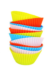 Stack of colorful cupcake cases isolated on white
