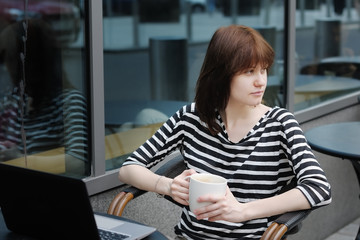 Thoughtful girl in a outdoor cafe