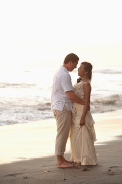 Beautiful beach marriage. the bride and groom against the sunset