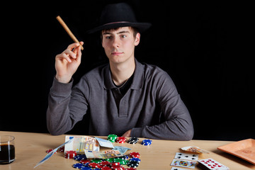 Young man at poker - obrazy, fototapety, plakaty