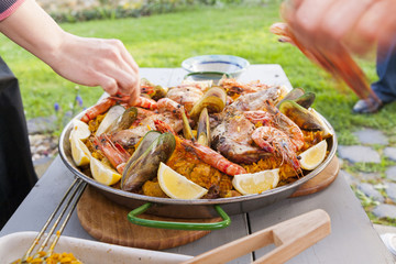 preparing home-made paella in garden