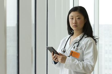 Female Asian doctor holding a tablet