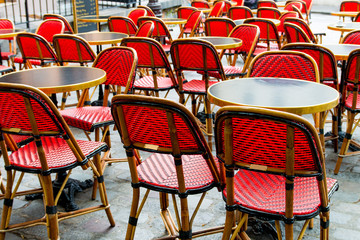 Street view of a coffee terrace with tables and chairs