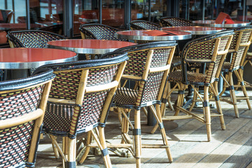 Street view of a coffee terrace with tables and chairs