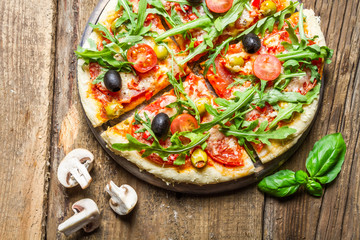 Freshly baked pizza with basil and tomatoes