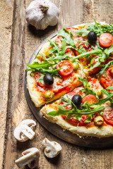 Freshly baked pizza on old cutting board