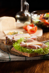 Sandwiches with cheese, ham and lettuce. Dark tone