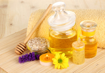 Fragrant honey spa with oils and honey on wooden table close-up