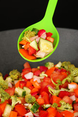 Vegetable ragout in wok, isolated on black