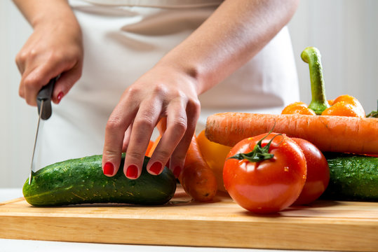 Woman Cutting Vegetables For A Salad