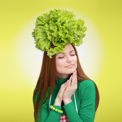 Portrait of smiling woman with the salad on her head