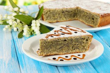 Delicious poppy seed cake on table close-up