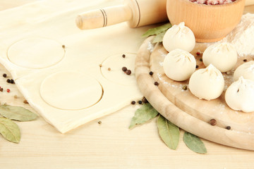 Raw dumplings and dough, on wooden table