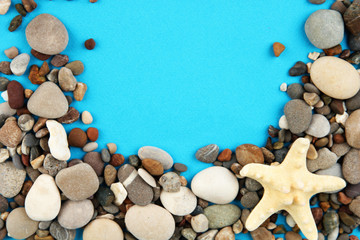 Fototapeta na wymiar Frame of sea stones on color background