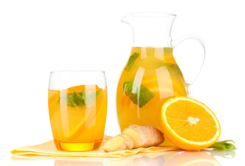 Orange lemonade in pitcher and glass isolated on white