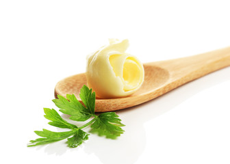 Butter curl on wooden spoon, isolated on white