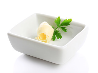 Butter curl on plate, isolated on white