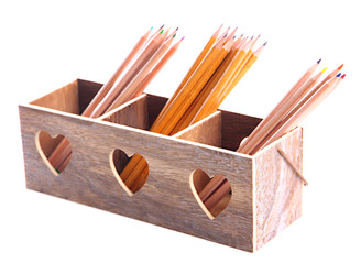 Different pencils in wooden crate, isolated on white