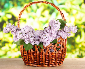 Fototapeta na wymiar Beautiful lilac flowers on table on bright background