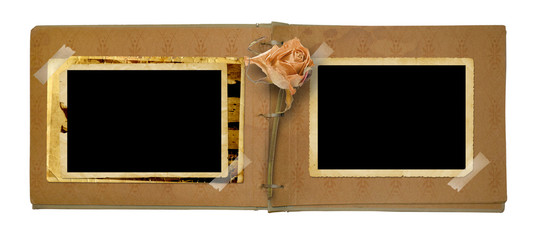 Old photo album with beautiful dried rose isolated on a white ba