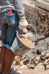 Labor carry sand in cistern for construction