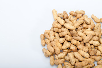 .Dried peanuts in closeup on the white background