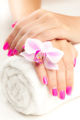 beautiful pink manicure with pink orchid and towel