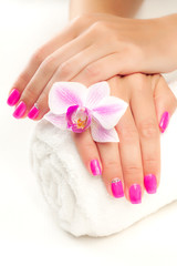 pink manicure with pink orchid and towel