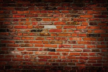 Old vintage red brick wall background with dark edges