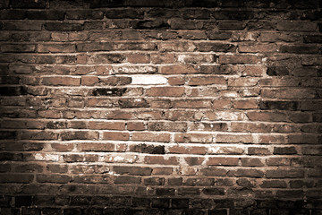 Old vintage grey brick wall background with dark edges