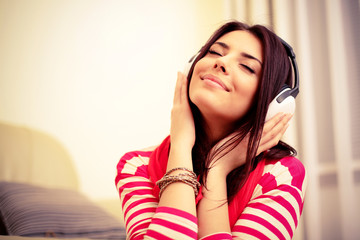 Young beautiful woman in bright outfit enjoying the music