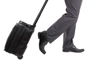 A business traveler with suitcase on white background