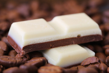 Cappuccino and white chocolate on coffee beans