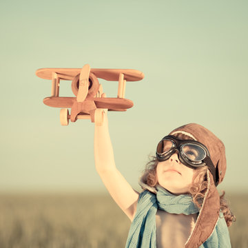 Happy Kid Playing With Toy Airplane