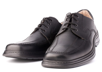Black glossy man’s shoes with shoelaces