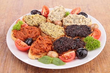 assortment of olive spread and toast