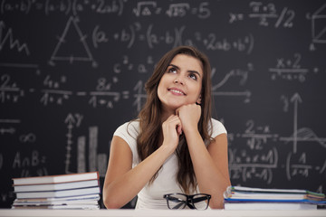 Happy woman sitting in classroom and looking up