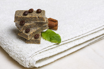 Homemade soap bars with coffee beans, cinnamon and lavender leaf