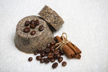 Handmade aromatic soap surrounded by coffee beans and cinnamon