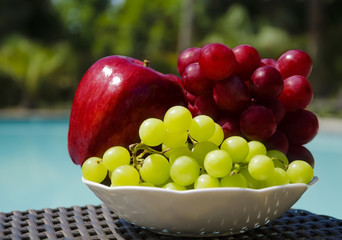 Apple and grape by the swimmimg pool