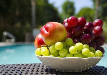 Peaches and grape by the swimmimg pool