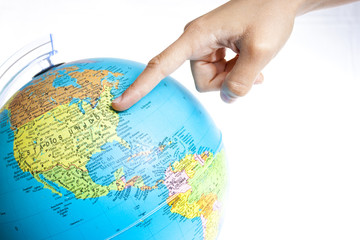 A Finger pointing to United States of America in a World Globe