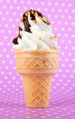 Tasty ice cream with chocolate, on purple background