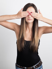 Young caucasian brunette Woman Covers Eyes With Hands