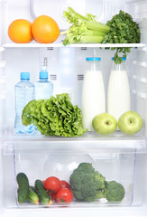 Open refrigerator with vegetarian food © Africa Studio
