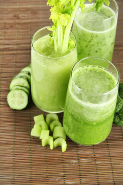 Glasses of green vegetable juice on bamboo mat