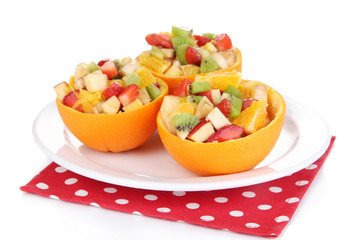 Fruit salad in hollowed-out orange isolated on white